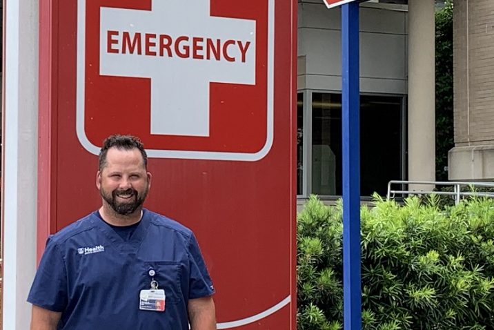 man in front of emergency sign