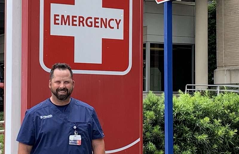 man in front of emergency sign