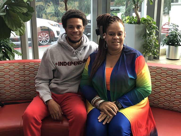 Young man and mom seated on couch