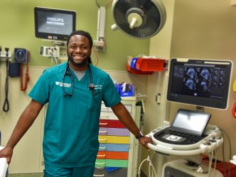 Man in green scrubs in the emergency room
