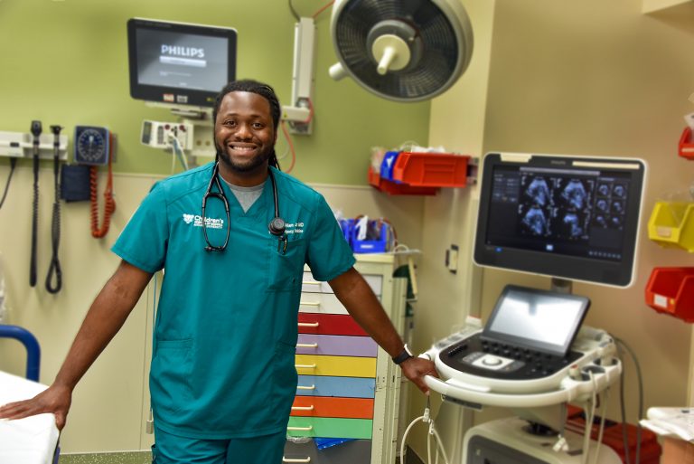Man in green scrubs in the emergency room