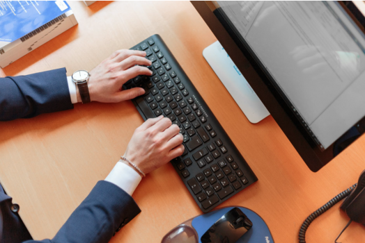 man typing on computer