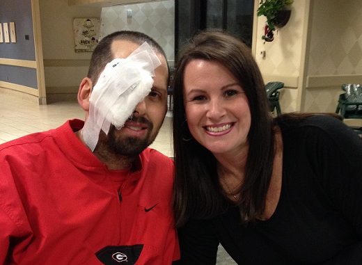 patient with eye bandage and wife