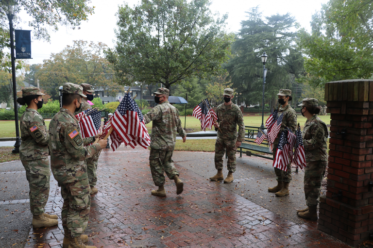 Members of military with flag