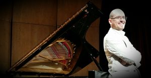 man smiling with piano