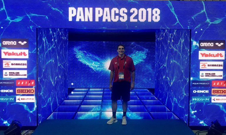 Man in front of sign