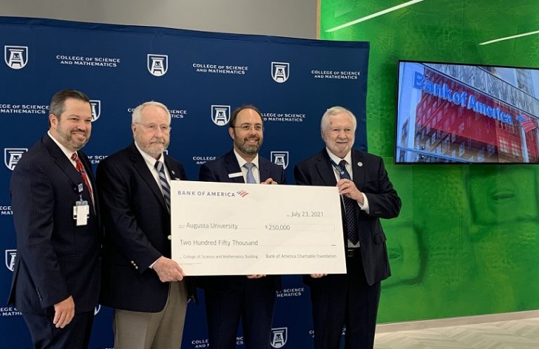 four men hold big check