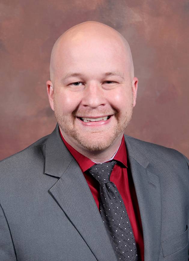 A bald man in a suit and tie