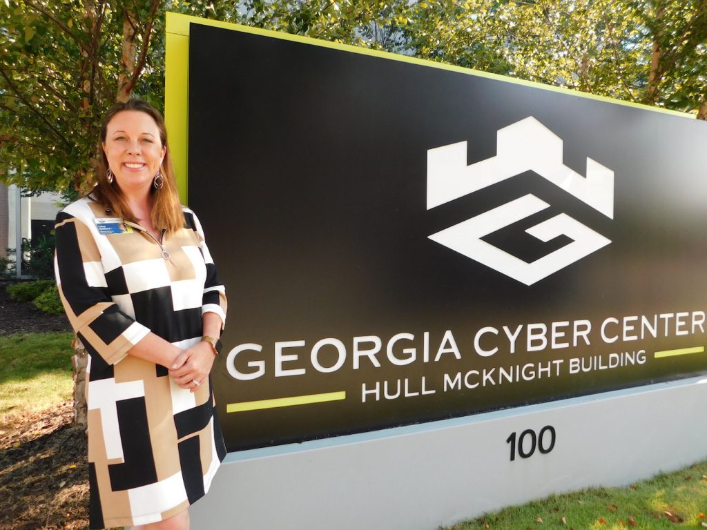 Woman standing by Georgia Cyber Center sign