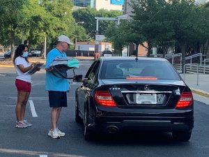 Man and woman standing near car