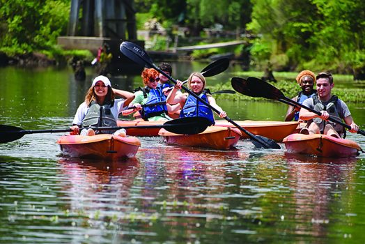 People in kayaks on river