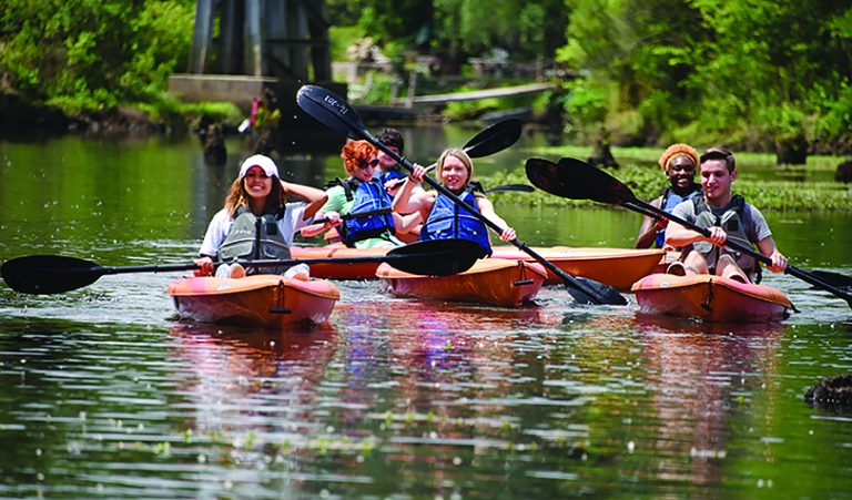 People in kayaks on river