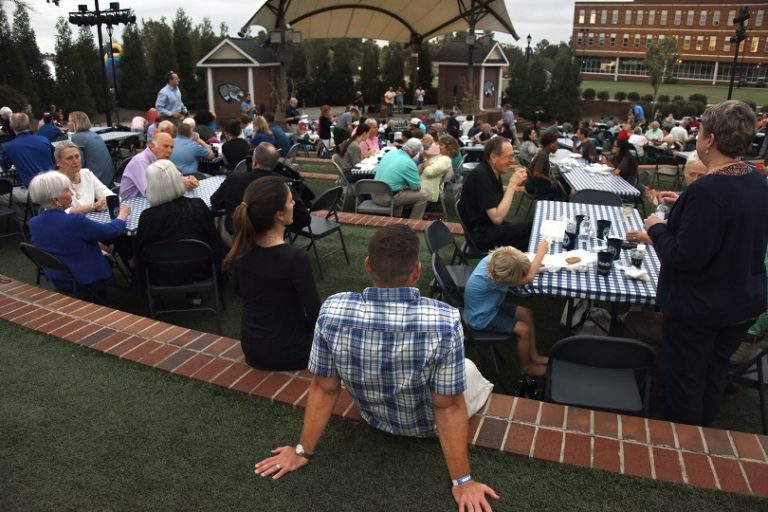 picnic tables filled with people