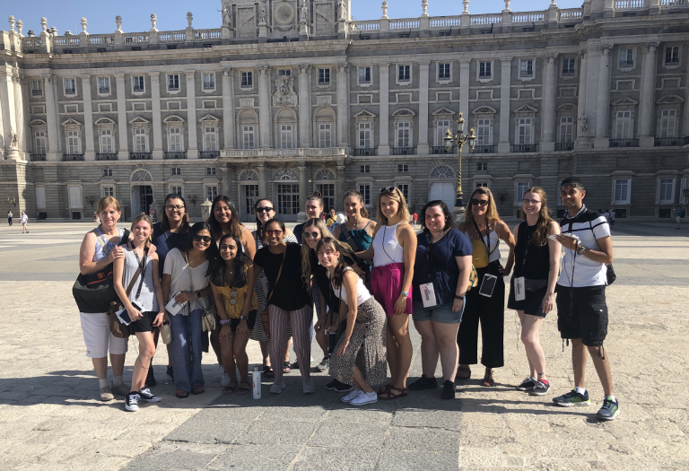 group of people in front of a palace