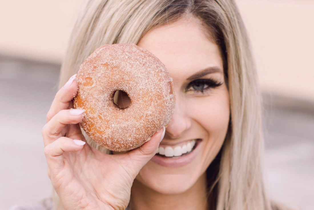 woman looking through donut hole