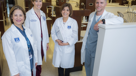 3 women and 1 man in whitecoats