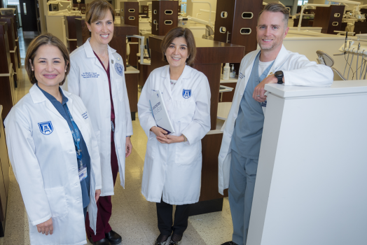 3 women and 1 man in whitecoats