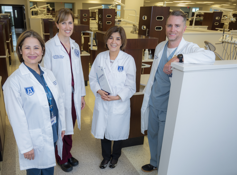 3 women and 1 man in whitecoats