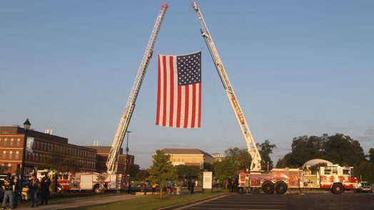Firetrucks displaying American flag