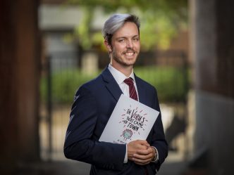 man standing with book