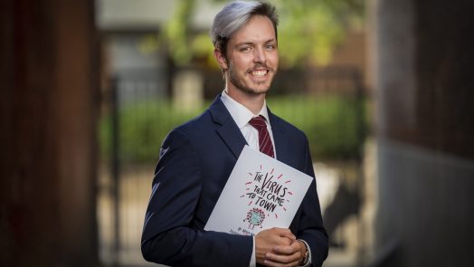 man standing with book