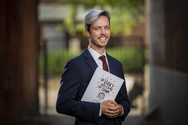 man standing with book