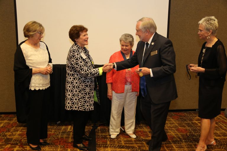 man shakes woman's hand