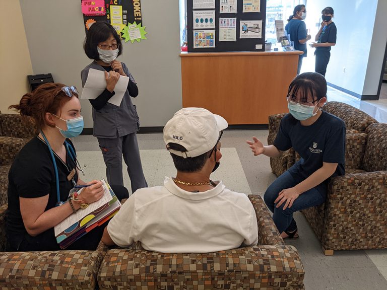 Women talking to a man