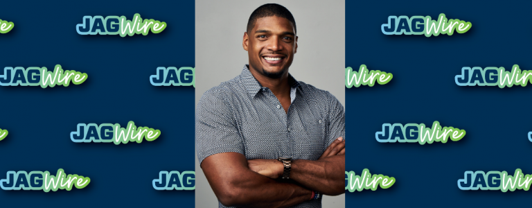 headshot of a man over a blue background