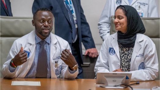 people in white coats speaking