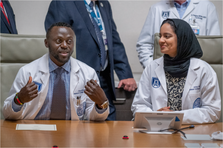 people in white coats speaking