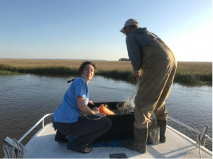 two people on a boat with fishing net