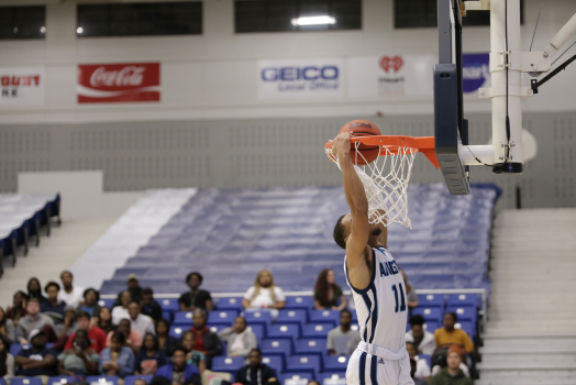 male player dunking a basketball