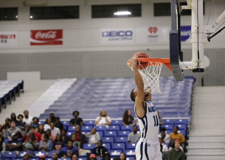 male player dunking a basketball