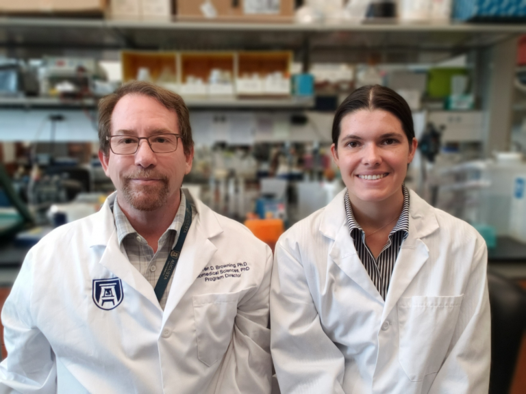 a man and a woman, both wearing whitecoats