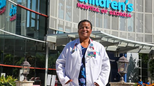 Woman in front of Children's hospital smiling