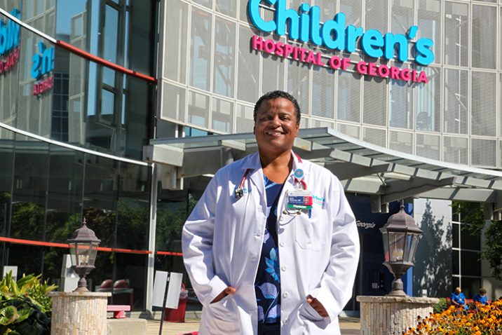 Woman in front of Children's hospital smiling