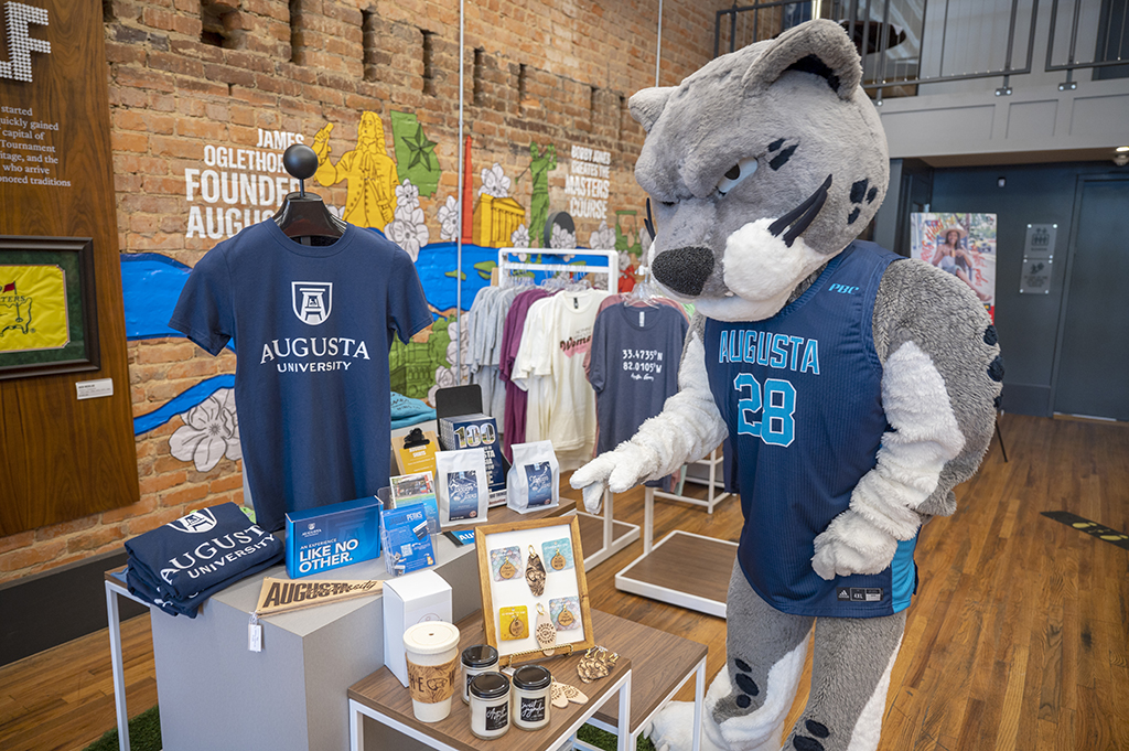 Mascot in front of merchandise