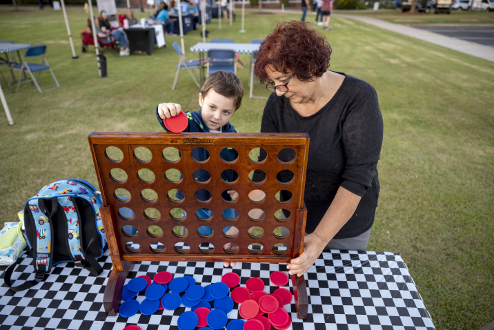 a woman and a boy playing Connect Four