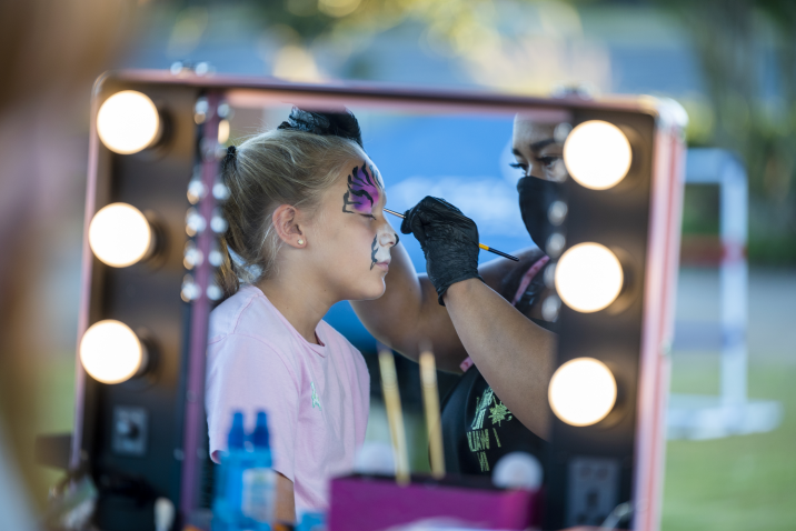 young girl getting face-painted