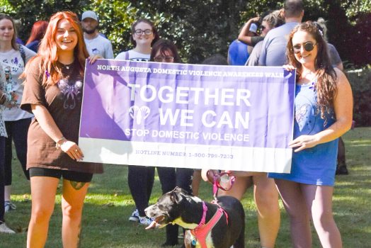 two women holding a sign