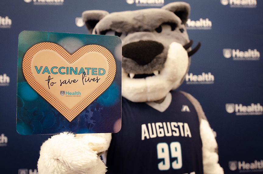 Mascot with sign: Vaccinated to Save Lives
