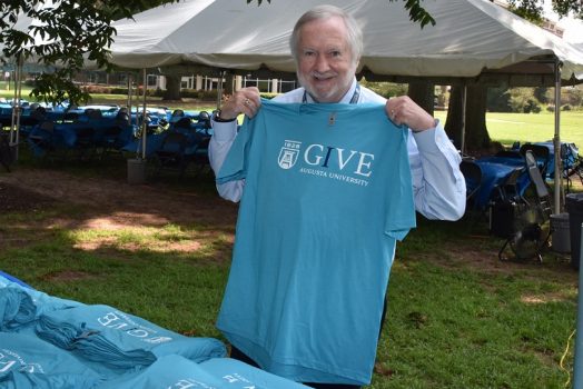 man holds t-shirt