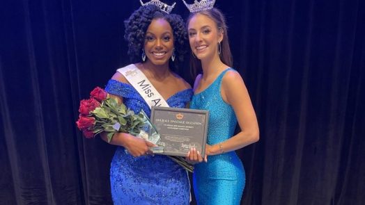 two women wearing blue dresses and crowns