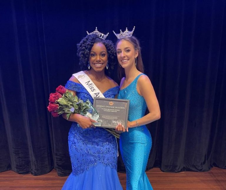 two women wearing blue dresses and crowns