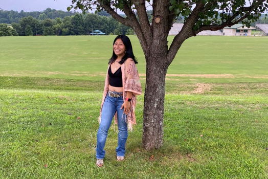 woman standing beside a tree