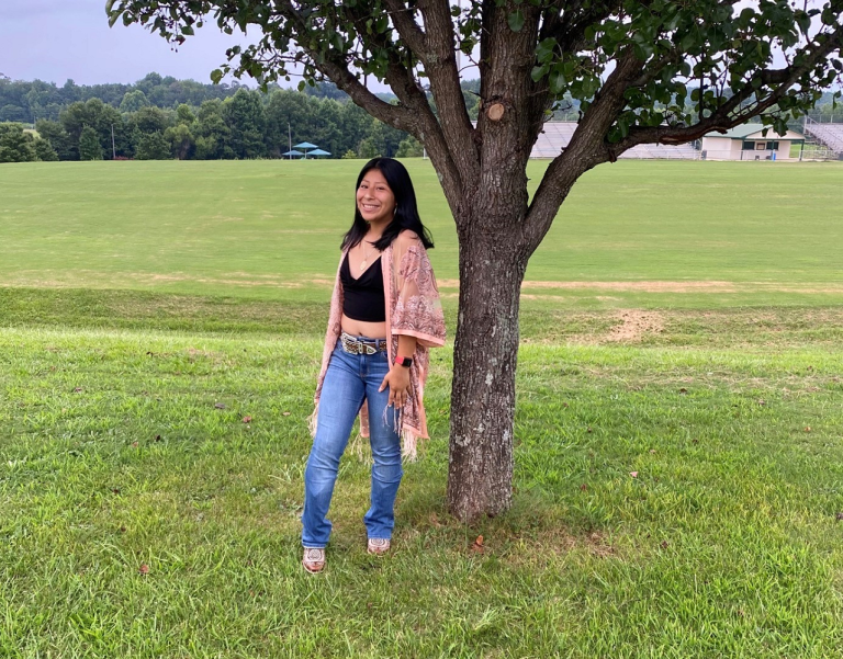 woman standing beside a tree