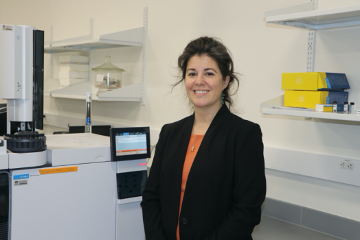 woman in front of science instrument