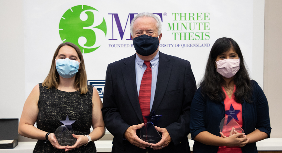 three people, all wearing masks, hold awards