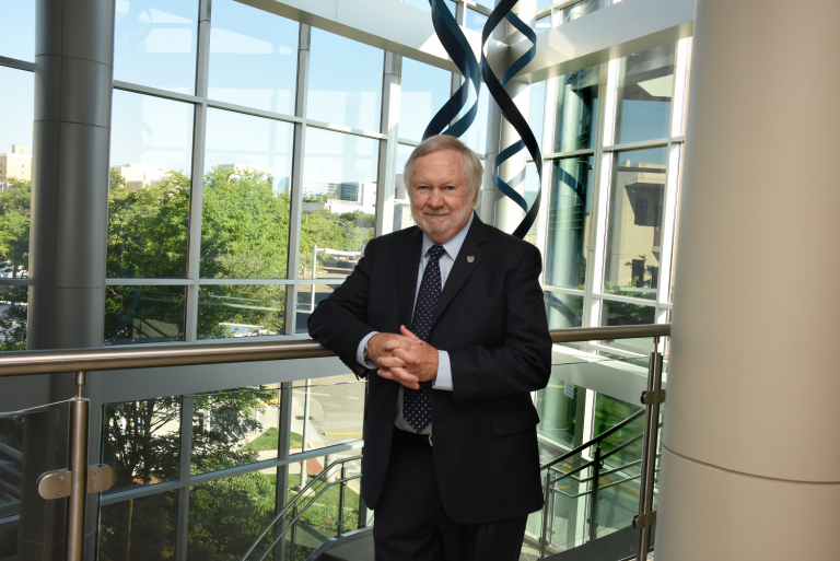 man in suit standing at balcony